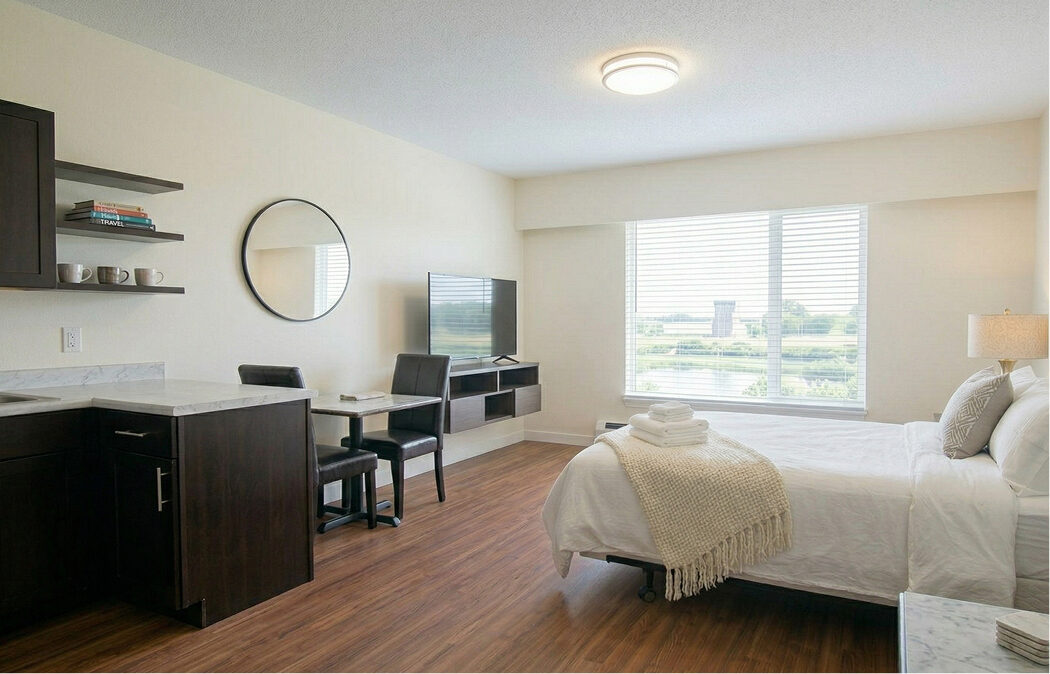 Single occupancy furnished studio with kitchenette and bed